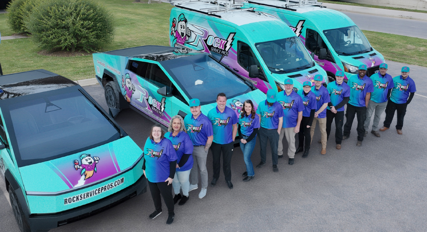 The Rock Service Pros team with their service vehicles